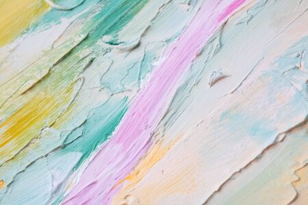 Smears of blue, pink, yellow and white paints on the wallの写真素材
