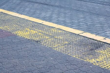 Old yellow sign bike path on the sidewalk close upの写真素材