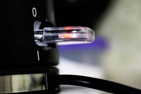 Power button on black electric kettle close upの写真素材