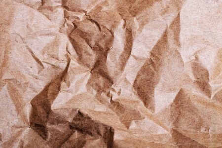 Crumpled brown paper close up, abstract background or textureの写真素材