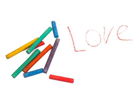 Colored crayons and word love isolated on a white background close upの写真素材