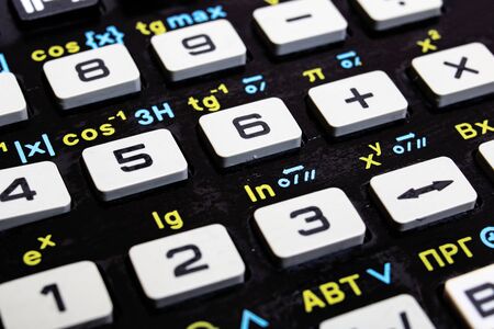 Engineering calculator buttons with formulas close up, background or texture
