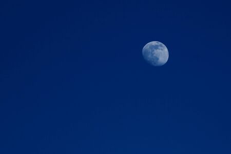 Moon in the blue night sky close up, copy spaceの写真素材