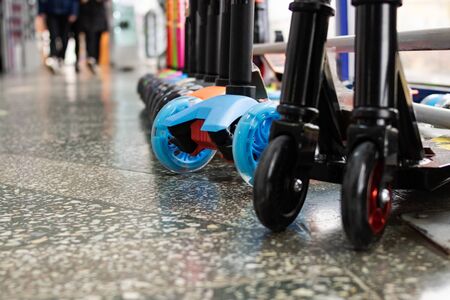 Wheels of various scooters in a row close upの写真素材