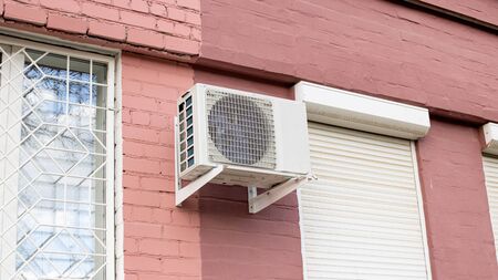 Air conditioning on a red brick building wall