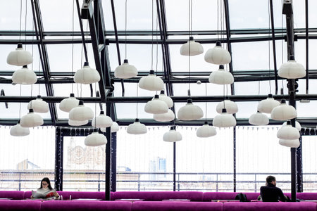 BELARUS, MINSK - DECEMBER 03, 2019: Two people in an empty cafe under the glass ceilingのeditorial素材