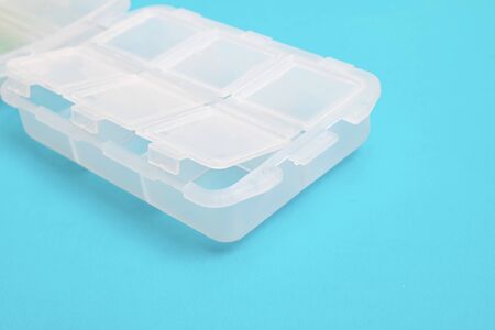 Plastic container for pills on a blue background