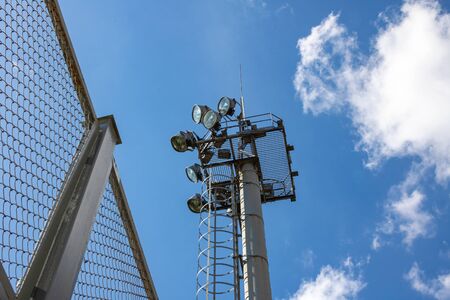 A large modern lantern against a blue sky close up