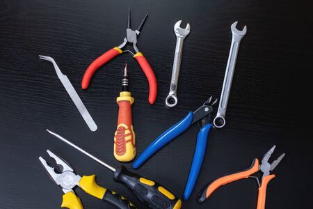 Screwdrivers and pliers, tools on wooden tableの写真素材