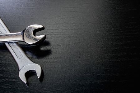 Two wrenches on a wooden table copy spaceの写真素材