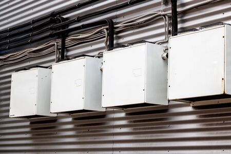 Metal boxes on the wall of a building close up