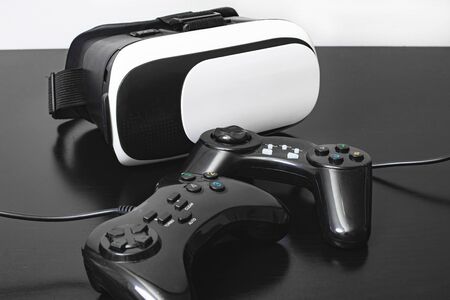 Black and white virtual glasses and two playing joystick closeup