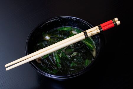 Japanese soup and sticks on a wooden tableの写真素材