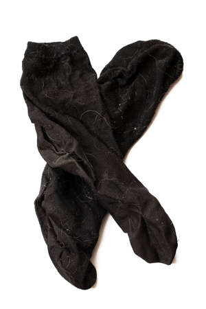 Dirty black socks isolates on a white background