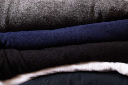 Stack of clothes on a wooden background close upの写真素材