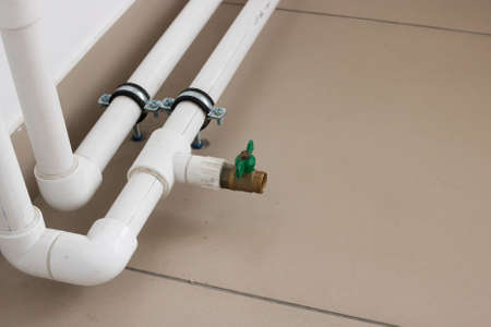 Pipes and radiator by the window close upの写真素材