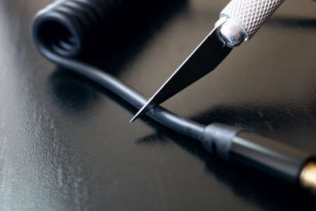 Cut thick wire with an engineering scalpel close upの写真素材