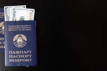 Belarusian passport and money dollars on wooden table, copy spaceの写真素材