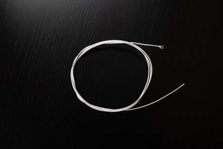 Guitar strings on a wooden table close up
