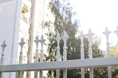 Pattern on a gray wrought iron fence in the sunlight
