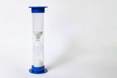 Hourglass with shadow on a white background, copy space