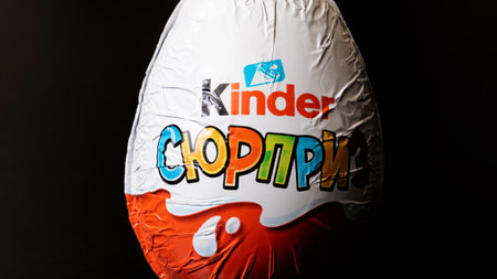 BELARUS, NOVOPOLOTSK - SEPTEMBER 29, 2020: Chocolate egg kinder surprise on black background close upのeditorial素材