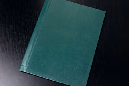 Closed folder for documents on wooden table close up