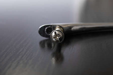 Door handle and bolt on a wooden table, repair