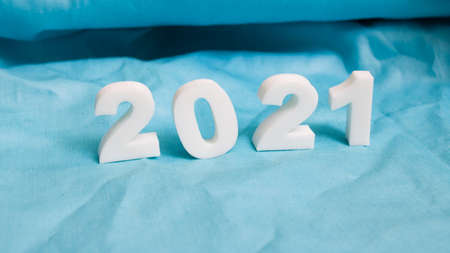 Numbers 2021 on a blue fabric background close upの写真素材