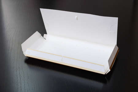 Empty chocolate box on a wooden table close up