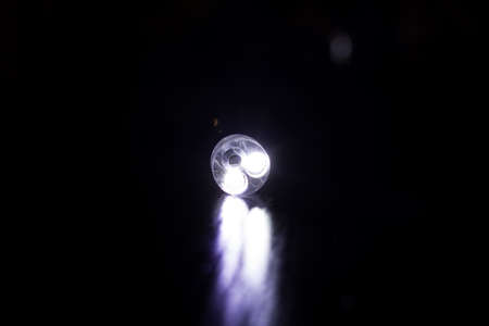 LED flashlight light in the dark close up