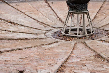 Disconnected old fountain system and autumn yellow leavesの写真素材