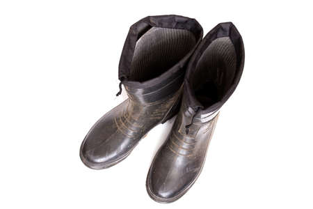 Old rubber boots, isolated on a white backgroundの写真素材