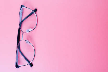 Glasses for vision on a pink background, copy spaceの素材 [FY310158488681]