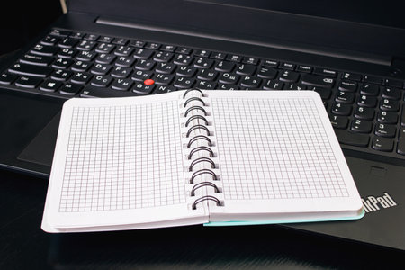 BELARUS, NOVOPOLOTSK - NOVEMBER 02, 2020: Laptop thinkpad and notepad close up