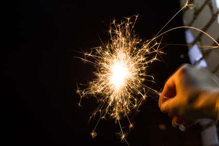 Bright sparkler light in the dark close up