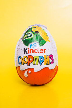 BELARUS, NOVOPOLOTSK - 08 DECEMBER, 2020: Kinder surprise chocolate egg on yellow backgroundのeditorial素材