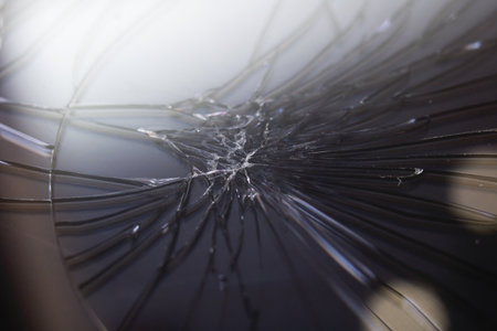 Broken mobile phone black display, cracks close up