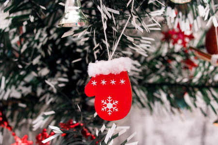 Red christmas decoration on a spruce branch close upの写真素材