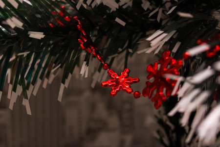 Red christmas decoration on a spruce branch close upの写真素材
