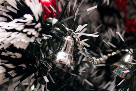 Red christmas decoration on a spruce branch close upの写真素材