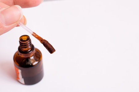 Cotton bud and jar of iodine on white background, copy spaceの写真素材