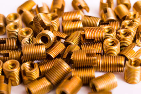 Small copper nuts on white background, background or texture