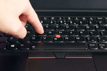 NOVOPOLOTSK, BELARUS - 06 FEBRUARY, 2021: Lenovo laptop keyboard and hand close upのeditorial素材