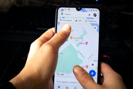 NOVOPOLOTSK, BELARUS - 06 FEBRUARY, 2021: Phone in hand and yandex taxi on displayのeditorial素材