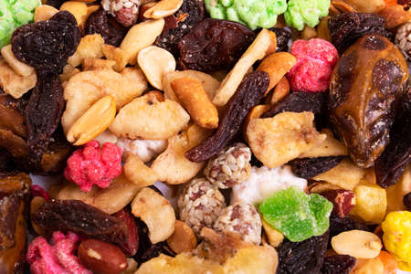 Multicolored dried fruits close up background or texture