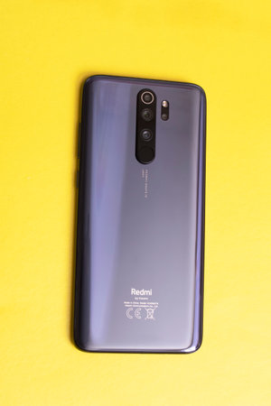 BELARUS, NOVOPOLOTSK - 25 FEBRUARY, 2021: Xiaomi redmi 8 pro phone on a yellow background