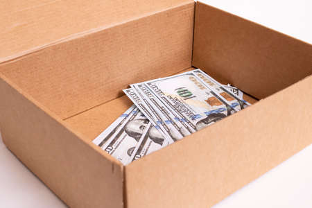 Heap of dollars in a box on a white background