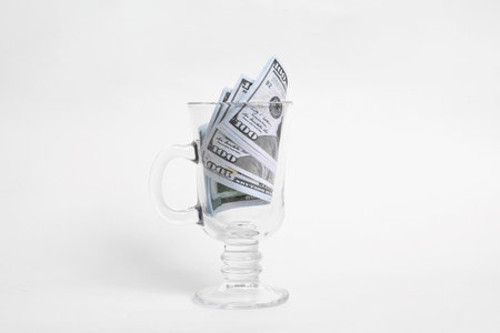 Dollars in a mug on a white background close upの写真素材