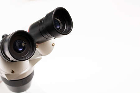 Large metal microscope on a white background, copy spaceの写真素材